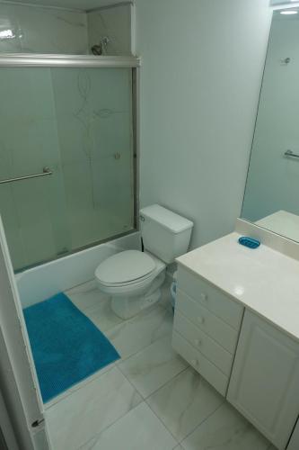 a bathroom with a toilet and a shower and a sink at Ocean Reserve STR-01045 in Miami Beach