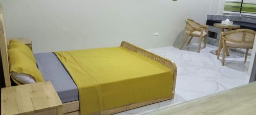 a bedroom with a bed and a table and chairs at Michaels Homestay - Farm Villa nr Patar Beach & Bolinao Falls in Bolinao