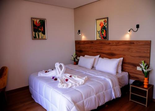 a bedroom with a large white bed with towels on it at Hotel beaux arts in Meknès