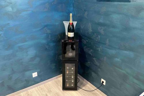 a bottle of wine sitting on top of a machine at Villa Spacieuse SPA Sauna Billiard Netflix in Strasbourg
