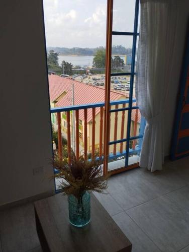 a potted plant sitting on a table in front of a window at Apto Nuevo, Tranquilo, Bonito, 5 min Plaza Principal in Guatapé