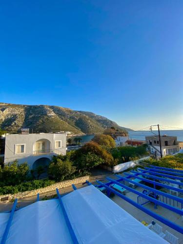a group of swimming pools with a view of the ocean at Sevasti Studios in Panormos Kalymnos