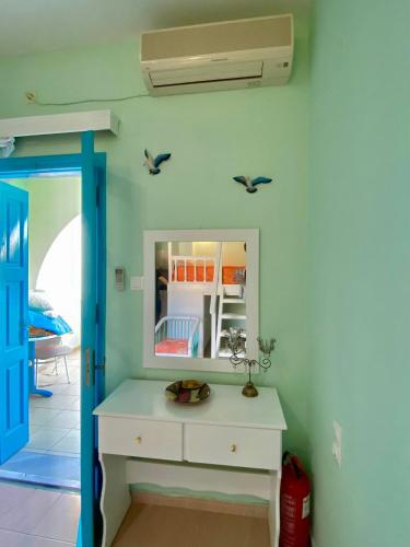 a room with a white dresser and a mirror at Sevasti Studios in Panormos Kalymnos