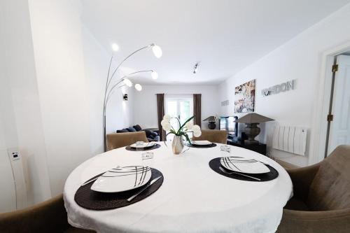 a white dining room with a white table and chairs at Luxury Apartment near Cascais Town & Marina in Cascais