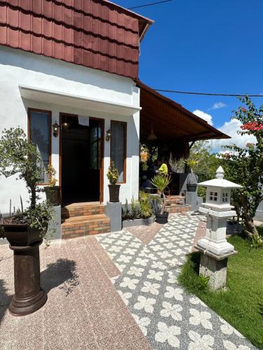 a house with a stone walkway in front of it at Penida Hills in Nusa Penida