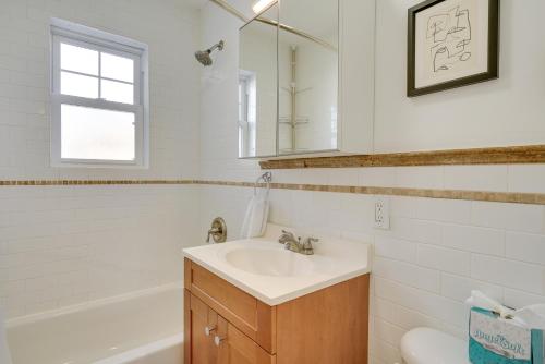 a bathroom with a sink and a toilet and a mirror at Asbury Park Condo Less Than Half-Mi to Beach and Boardwalk! in Asbury Park