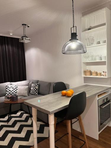 a kitchen with a table with oranges on it at LUMI Apartament Mokotów in Warsaw