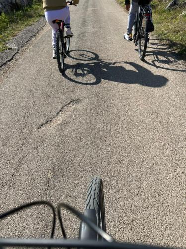 two people riding bikes down a road at Palazzo Muro Leccese Relais de Charme & Wellness in Muro Leccese