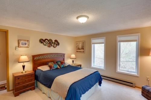 een slaapkamer met een bed en 2 ramen bij Catskills Home, 5 Mins to Windham Mtn Resort! in Windham