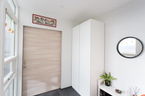 a hallway with a wooden door and a mirror at Glaumbær III in Varmahlid