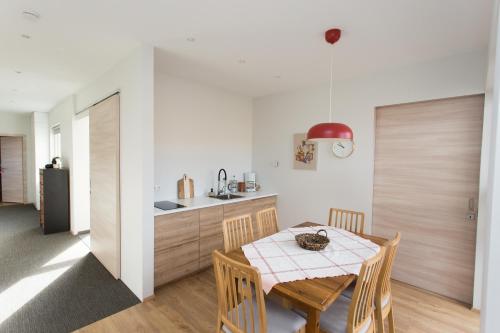 a kitchen and dining room with a table and chairs at Glaumbær III in Varmahlid