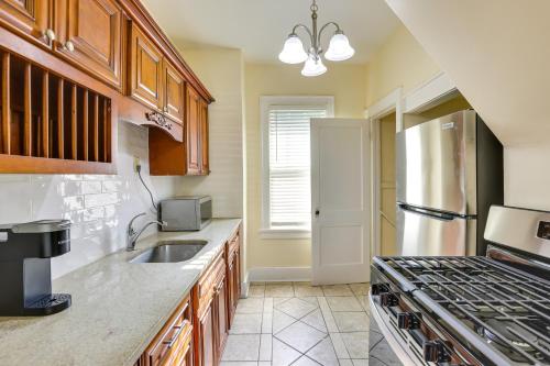 a kitchen with a sink and a stove at Quaint Omaha Home Less Than 5 Mi to Downtown! in Omaha
