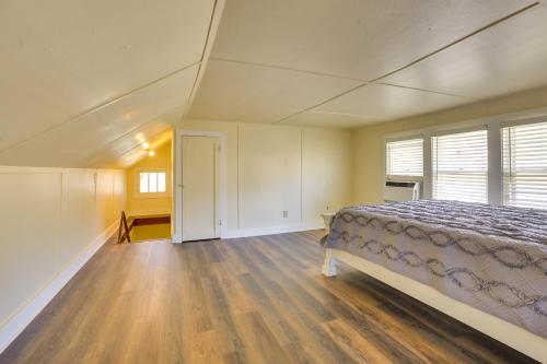 a bedroom with a bed and a large window at Quaint Omaha Home Less Than 5 Mi to Downtown! in Omaha
