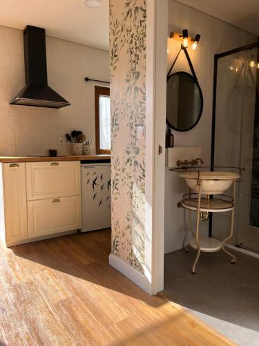a kitchen with a sink and a mirror at Casa dos meus avós - AL & Events in Vila Nova de Gaia