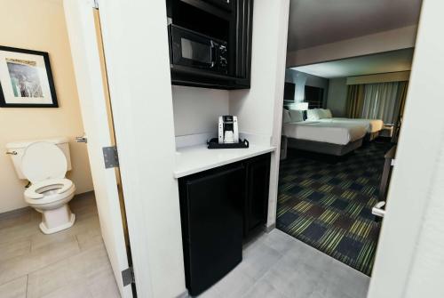 a hotel room with a bathroom with a toilet at La Quinta Inn & Suites by Wyndham Ankeny IA - Des Moines IA in Ankeny