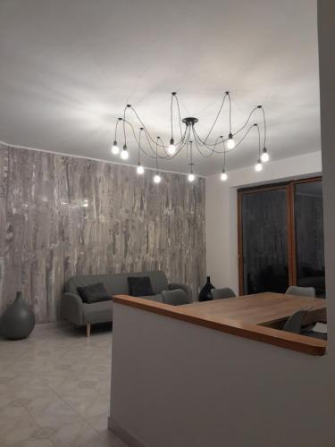a living room with a chandelier hanging over a table at Fuori dal Borgo.... in Vitorchiano