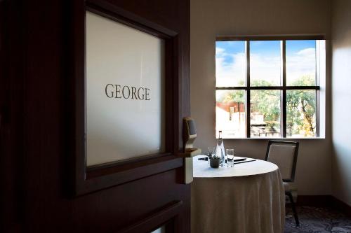 a room with a table in front of a window at The Yorkville Royal Sonesta Hotel Toronto in Toronto