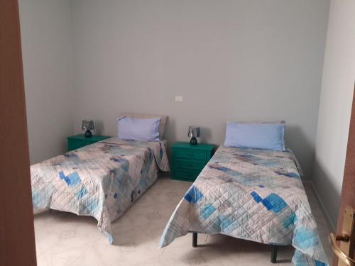 two beds sitting next to each other in a room at Fuori dal Borgo.... in Vitorchiano