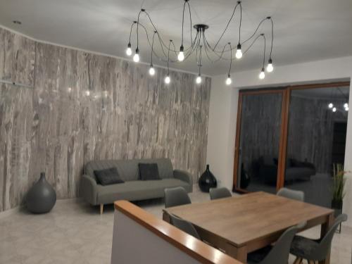 a living room with a table and a couch at Fuori dal Borgo.... in Vitorchiano