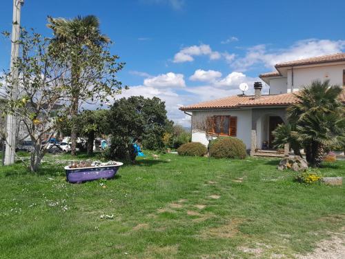a house with a yard with a boat in the grass at Fuori dal Borgo.... in Vitorchiano