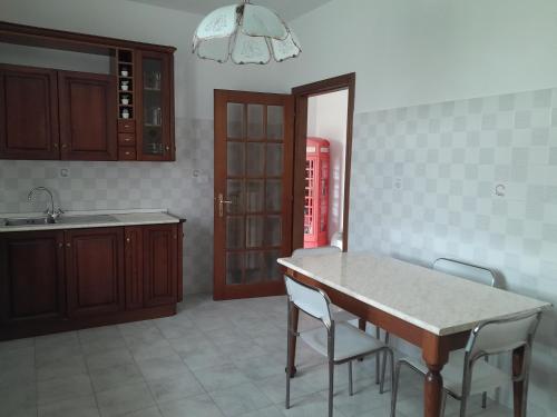a kitchen with a table and chairs and a sink at Fuori dal Borgo.... in Vitorchiano