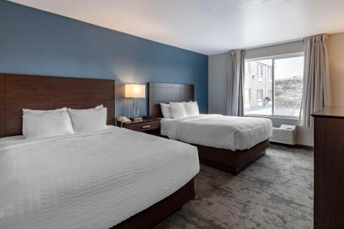 a hotel room with two beds and a window at Clarion Inn Kingman I-40 Route 66 in Kingman