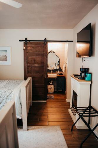a bedroom with a bed and a fireplace and a mirror at Taylor Creek Lodge in Gold Beach