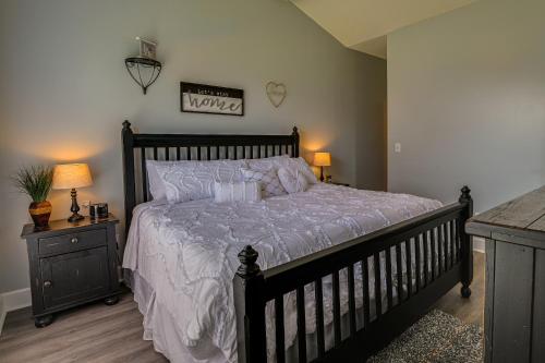 a bedroom with a black bed with a white comforter at Idyllic Myrtle Beach Condo Golf Course On-Site in Myrtle Beach