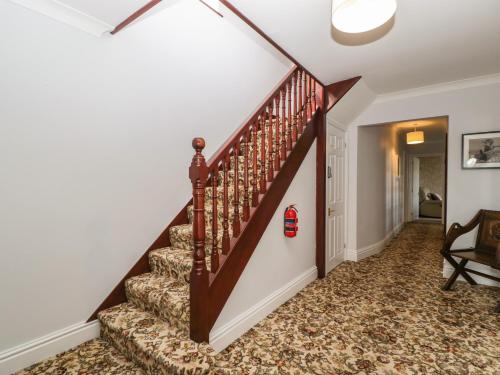 a staircase in a home with white walls at Moors Farm in Cinderford