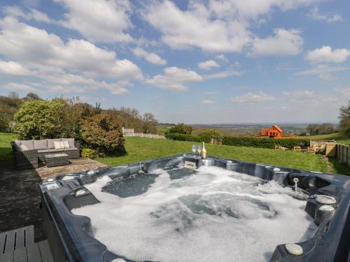 a hot tub in the middle of a yard at Moors Farm in Cinderford