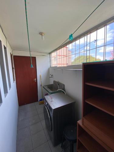 a small room with a sink and a window at Apart La Posada in Tacna