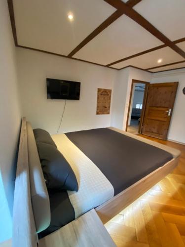 a bedroom with a large bed in a room at Cathédrale Saint-Nicolas Bnb in Fribourg