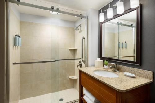 a bathroom with a sink and a shower at Courtyard by Marriott Atlantic City Beach Block in Atlantic City