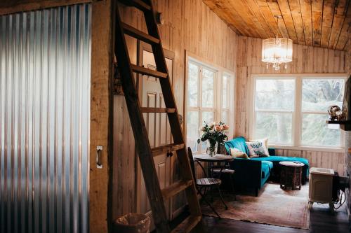 a living room with a spiral staircase in a house at Taylor Creek Lodge in Gold Beach