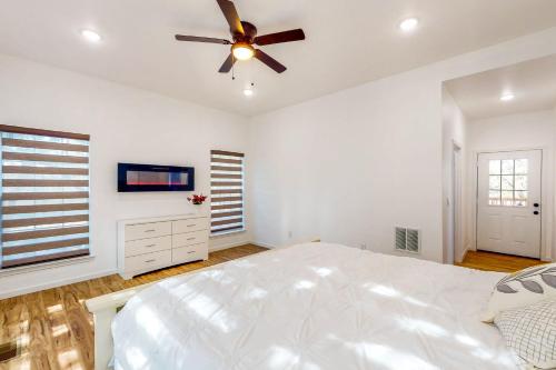 a white bedroom with a bed and a ceiling fan at Ark Ranch in Princeton
