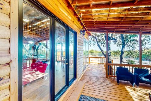 a screened porch with glass windows and blue chairs at Ark Ranch in Princeton