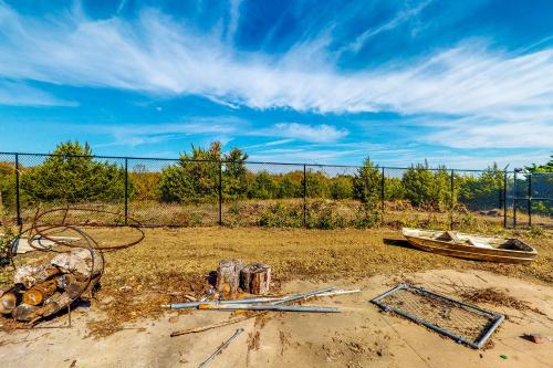a field with a fence and a boat on the ground at Ark Ranch in Princeton
