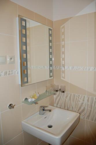 a bathroom with a sink and a mirror at Hotel Academic in Zvolen