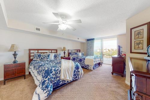 a bedroom with two beds and a ceiling fan at Yacht Club Villas 3-505 in Myrtle Beach