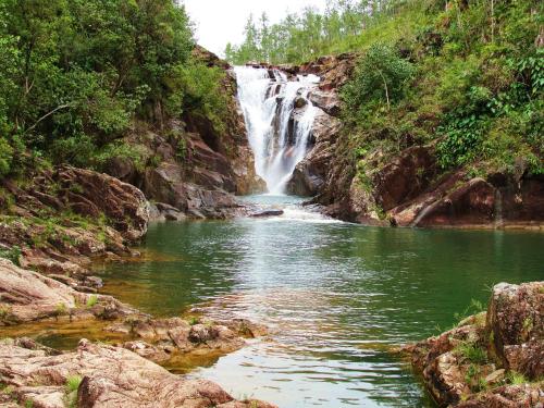 a waterfall in the middle of a river at Mariposa Jungle Lodge in San Ignacio