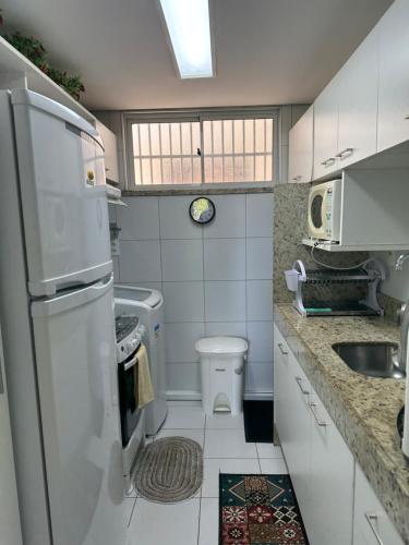 a small kitchen with a sink and a toilet at Palm Beach Residence in Aquiraz