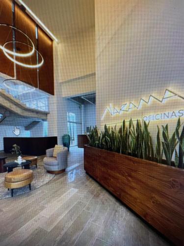 an office lobby with a large planter in the middle at Lovely and Peaceful Home in Guatemala