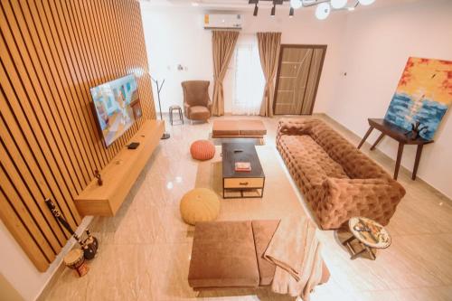 a living room with a couch and a table at Big chill stays in Apenkwa