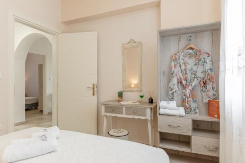 a bedroom with a bed and a dresser and a mirror at Villa of Roses in Naxos - Private villa with pool in Naxos Chora