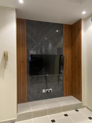 a mirror in a bathroom with a tv on the wall at قاردن وحدات سكنية خاصة in Al Madinah