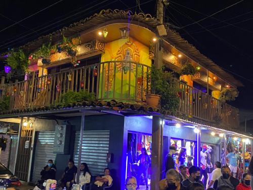 a group of people sitting outside of a building at night at Boutike Art & Wellness in Concepción de Ataco