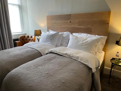 a bedroom with two beds with white pillows at The Viewmount Luxury Boutique in Kingussie