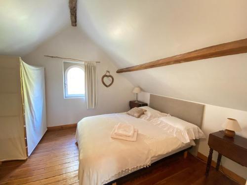 a bedroom with a white bed and a window at Cottage, Gulleville in Ganzeville