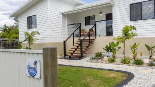 a home with a white house at Beach Shack Bongaree in Bongaree
