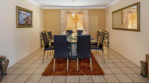 a dining room with a table and chairs at Paradise On Banksia Canal in Banksia Beach